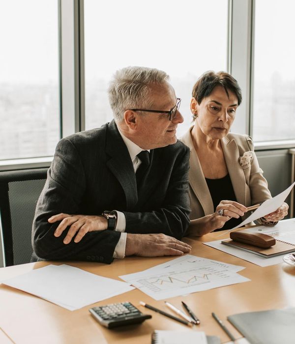 Corporate team in meeting room analyzing investment documents